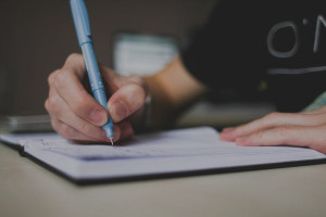 Student writing on a piece of paper